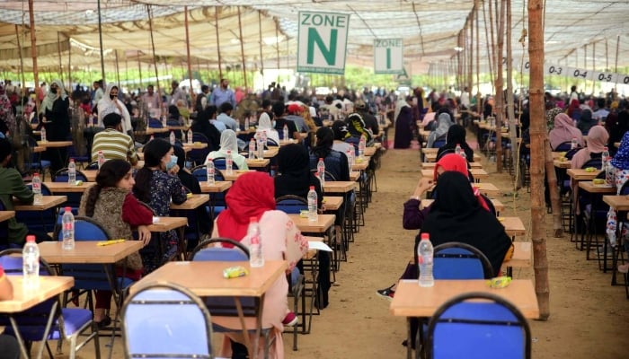 Students are busy in solving their questionnaire during the Medical and Dental College Admission Test (MDCAT) held at NED University in Karachi on November 13, 2022. —PPI