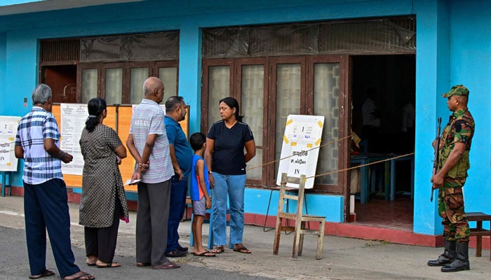 People wait in line outside a polling station minutes before the start of voting in Sri Lanka’s presidential election in Colombo on September 21, 2024. — AFP