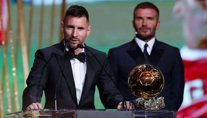 Inter Miami co-owner David Beckham stands behind Argentine football legedn Lionel Messi as he gives a speech after receiving his Ballon dOr award on October 30, 2023. — Reuters