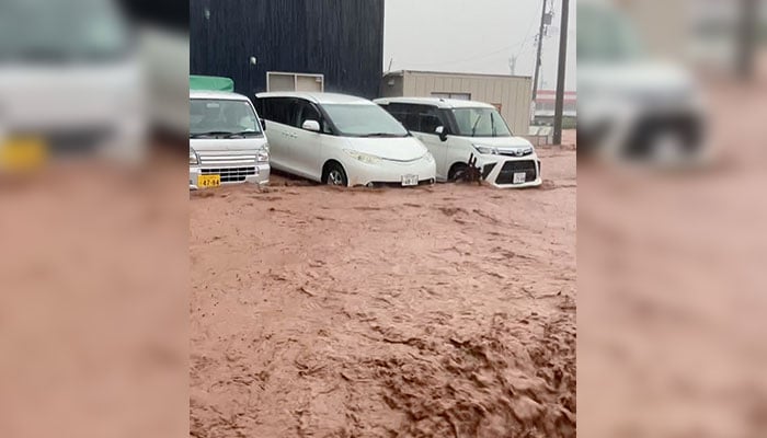 Vehicles are partially submerged in floodwater, amidst heavy rains, in Wajima, Ishikawa Prefecture, Japan, September 21, 2024. — Reuters