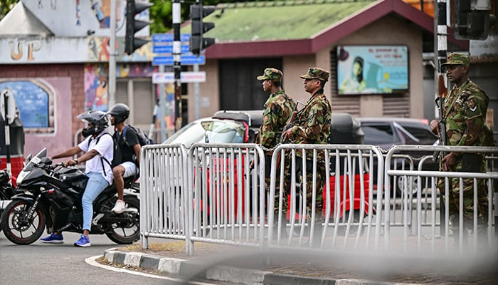 Security personnel stand guard on a roadside after the end of voting in Sri Lankas presidential election in Colombo on September 21, 2024. — AFP