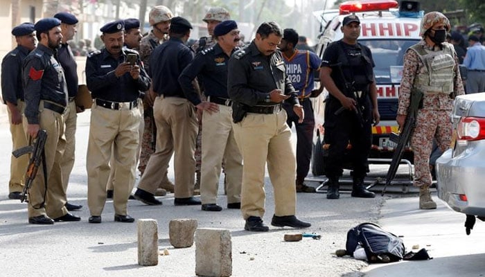 Police and Sindh Rangers officials gather near the Chinese consulate in Karachi. — Reuters/File