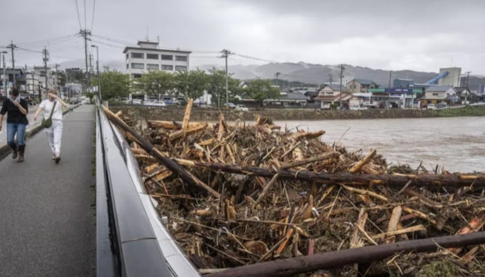 Debris from flooding piles up at a bridge in Wajima city on September 22, 2024. —AFP