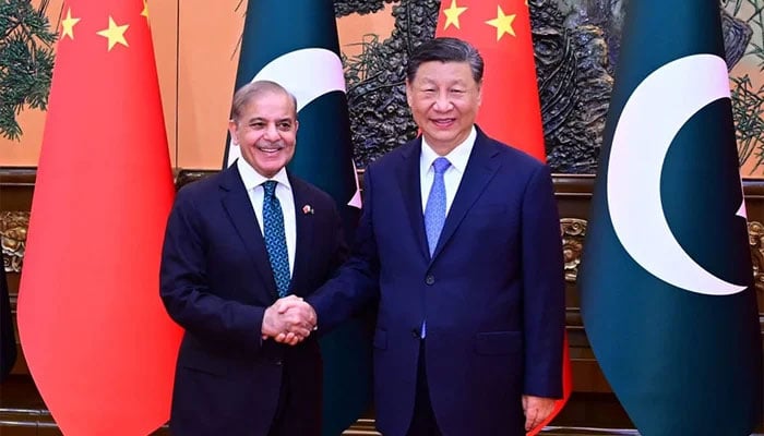 PM Shehbaz Sharif (left) shakes hand with Chinese President Xi Jinping in Beijing on 7 June 2024. — APP