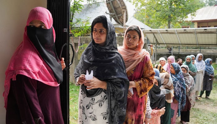 Women wait in line to vote outside a polling station during the second phase of the assembly elections, in Indian Illegally Occupied Jammu and Kashmirs Budgam district on September 25, 2024. — Reuters