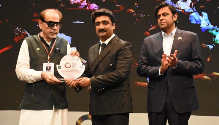 Provincial Minister of Culture and Tourism, Syed Zulfiqar Ali Shah (L) receiving a shield from the President of the Arts Council Pakistan Muhammad Ahmed Shah at the inauguration ceremony of the World Culture Festival in Karachi, Sindh on September 26, 2024. — Supplied