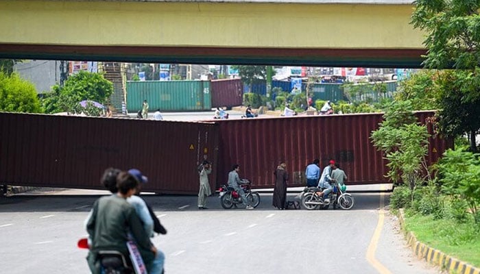 A representational image showing shipping containers blocking a road in Islamabad on July 26, 2024. — AFP