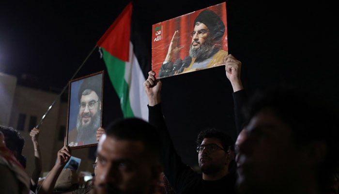 Demonstrators carry pictures of Lebanons Hezbollah leader Sayyed Hassan Nasrallah during a protest, following his killing in an Israeli airstrike in Beiruts southern suburbs on Friday, outside Al Kalouti mosque near the Israeli embassy in Amman, Jordan September 28, 2024. —Reuters