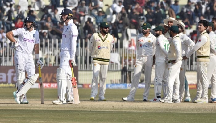 Pakistans players wait for the third umpires decision for Englands Zak Crawleys dismissal at Pindi Cricket Stadium, Rawalpindi, on December 4, 2022. —Reuters