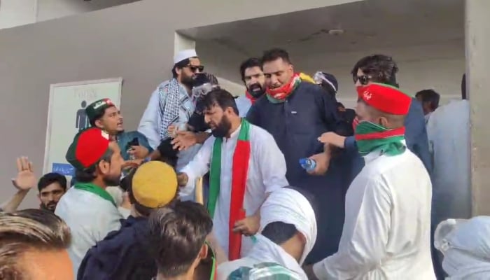 Pakistan Tehreek-e-Insaf (PTI) workers gathered outside a building on September 28, 2024. —Screengrab/ Reporter