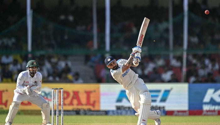 India’s Virat Kohli (right) plays a shot during the fourth day of the second Test cricket match between India and Bangladesh at the Green Park Stadium in Kanpur on September 30, 2024. — AFP