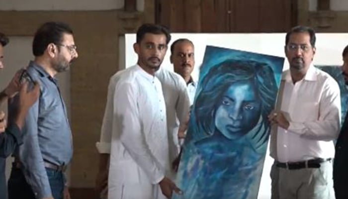 Artist Saifi Soomro pictured during the handover ceremony of his lost paintings at Frere Hall, Saddar, Karachi, Pakistan on September 30, 2024. — Screengrab via Geo News