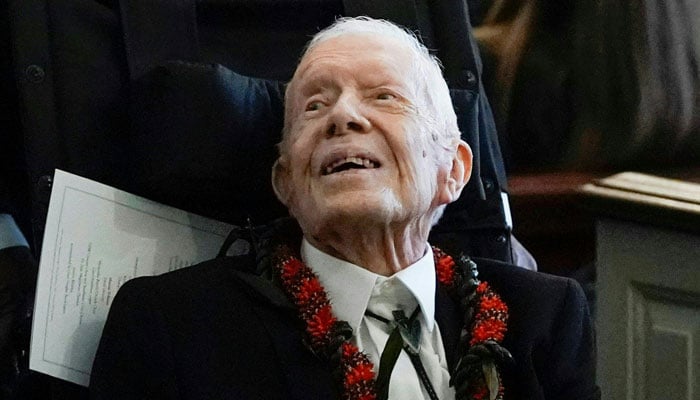 Former US president Jimmy Carter departs after the funeral service for his wife and former first lady Rosalynn Carter at Maranatha Baptist Church, in Plains, Georgia on November 29, 2023. — AFP