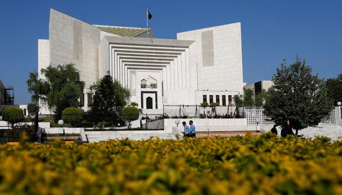 Police officers walk past the Supreme Court of building, in Islamabad on April 6, 2022. — Reuters