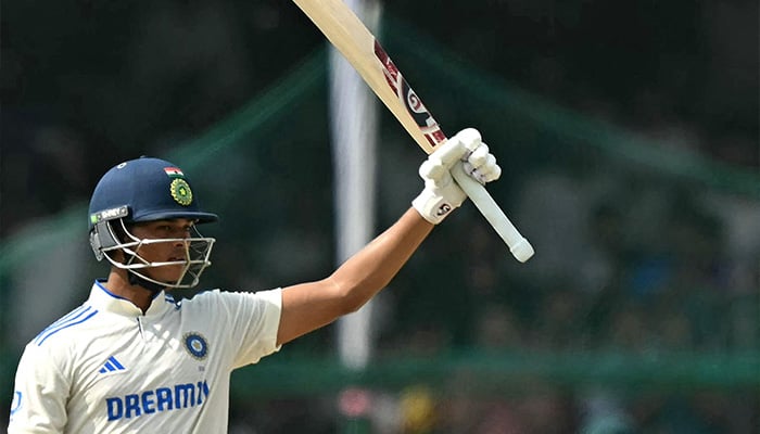 Indias Yashasvi Jaiswal celebrates after scoring a half-century during the fifth and final day of the second Test cricket match between India and Bangladesh at the Green Park Cricket Stadium in Kanpur on October 1, 2024. — AFP