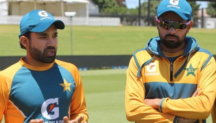 Mohammad Rizwan (left) and Babar Azam stand together on a cricket field. — PCB/File