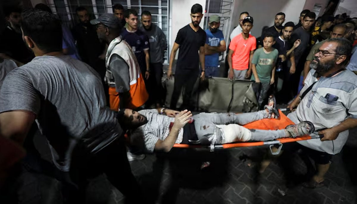 An injured person is assisted at Shifa Hospital after hundreds of Palestinians were killed in a blast at Al-Ahli hospital in Gaza that Israeli and Palestinian officials blamed on each other in Gaza City, Gaza Strip, October 17, 2023. — Reuters