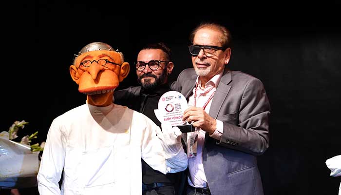 Arts Council President Ahmed Shah presenting a shield to French artist Alien Voyagers on October 4, 2024. — Facebook/ ACPKHI