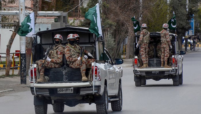 Security personnel patrol with vehicles on a street in Quetta, on March 25, 2020. — AFP