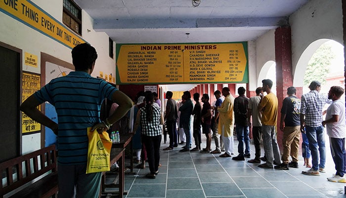 People wait in line outside a polling station to vote during the state assembly elections, in Karnal in the northern state of Haryana, India, October 5, 2024. — Reuters