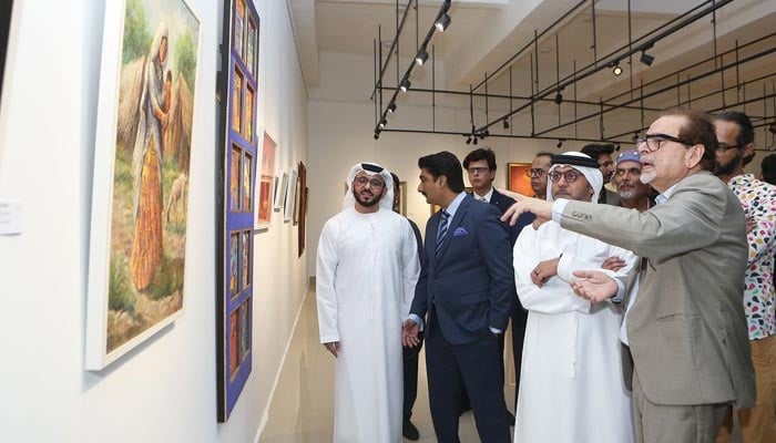 ACP President Muhammad Ahmed Shah gesturing towards a painting. — Instagram/@acpkhiofficial