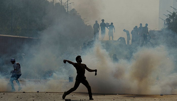 A supporter of jailed former Pakistani Prime Minister Imran Khans party, the Pakistan Tehreek-e-Insaf (PTI), throws back a tear gas shell during an anti-government rally in Islamabad, Pakistan, October 5, 2024. — Reuters