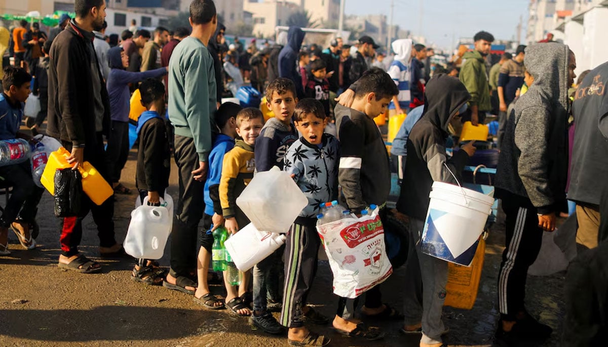 Palestinian children queue as they wait to collect drinking water, amid shortages of drinking water, as the conflict between Israel and Hamas continues, in Rafah, in the southern Gaza Strip January 4, 2024. — Reu