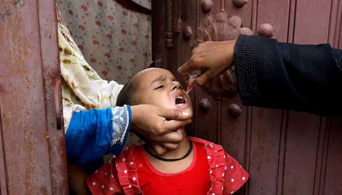 A girl receives polio vaccine drops, during an anti-polio campaign, in a low-income neighborhood in Karachi on July 20, 2020. — Reuters