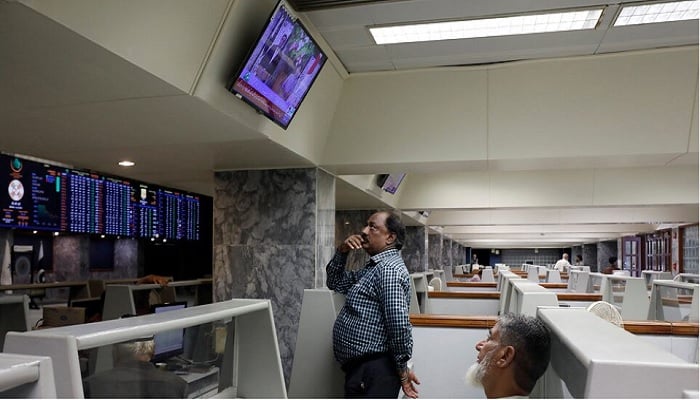 Stock brokers monitor new on television screen at a booth, during a trading session at the Pakistan Stock Exchange, in Karachi, Pakistan July 3, 2023. — Reuters