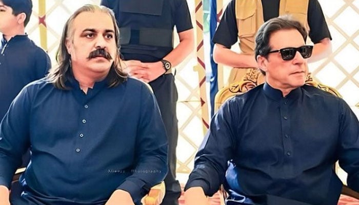 KP CM Ali Amin Gandapur (left) is seated with PTI founder Imran Khan in this photo shared by party. — Instagram/@ptiofficial