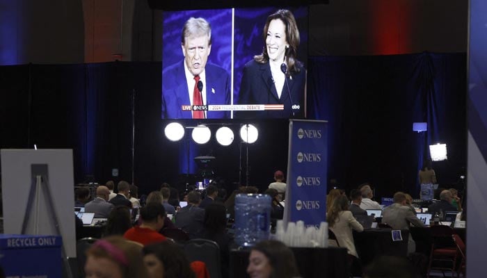 Members of the media use a screen to watch the presidential debate, as Donald Trump and Kamala Harris attend a presidential debate hosted by ABC in Philadelphia, Pennsylvania, US, September 10, 2024. — Reuters