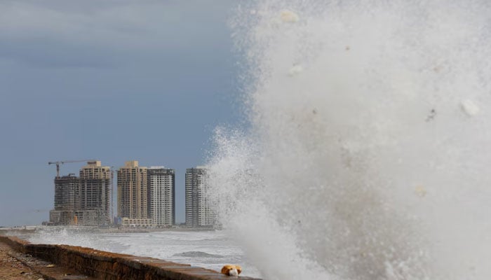 View of residential buildings as the rising waves splash, before the arrival of the cyclonic storm, Biparjoy, over the Arabian Sea, at Clifton Beach, in Karachi, June 13, 2023. — Reuters