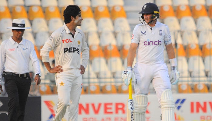 Pakistans bowler Naseem Shah (L) and Englands Joe Root during Pak vs Eng first Test, day three at the Multan Cricket Stadium on October 9, 2024. — PCB