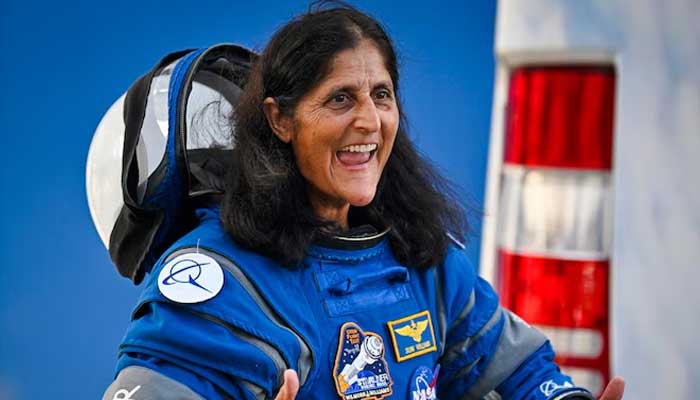 Nasa astronaut Suni Williams gestures as she prepares to depart the Neil A. Armstrong Operations and Checkout Building. — AFP