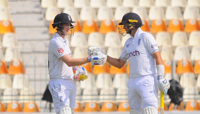 Englands Joe Root and Harry Brook interact on the fourth day of the first Test against Pakistan at Multan Cricket Stadium on October 10, 2024. — PCB