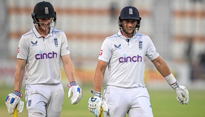 Englands Joe Root and Harry Brook (left) walk back to the pavilion at the end of the third day of the first Test cricket match between Pakistan and England at the Multan Cricket Stadium in Multan on October 9, 2024. —AFP