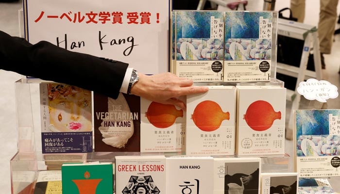 A Kinokuniya bookstore staff displays a book by the winner of the 2024 Nobel Prize in Literature, South Korean author Han Kang, at the bookstore in Tokyo, Japan, October 10, 2024. – Reuters