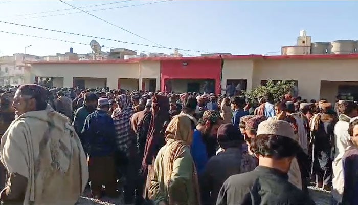 People gathered outside a medical facility where bodies of the deceased miners were kept, seen in this still taken from a video. — Reporter