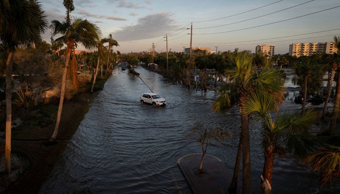 A drone view shows a car driving through a flooded street following Hurricane Milton in Siesta Key, Florida, US, October 10, 2024. — Reuters