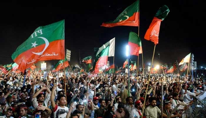 PTI workers at an election rally. — AFP/File