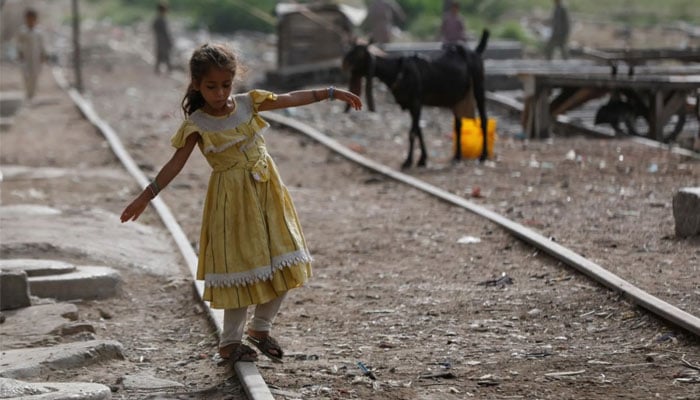 Representational image of a girl balances herself while walking on an abandoned railway track in a slum area in Karachi, Pakistan July 10, 2023. — Reuters