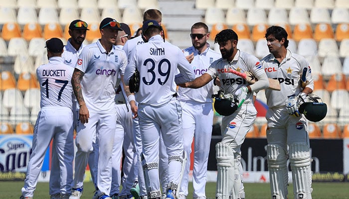 Pakistan and England players shake hands on the fifth day of the first Test at Multan Cricket Stadium on October 11, 2024. — Reuters