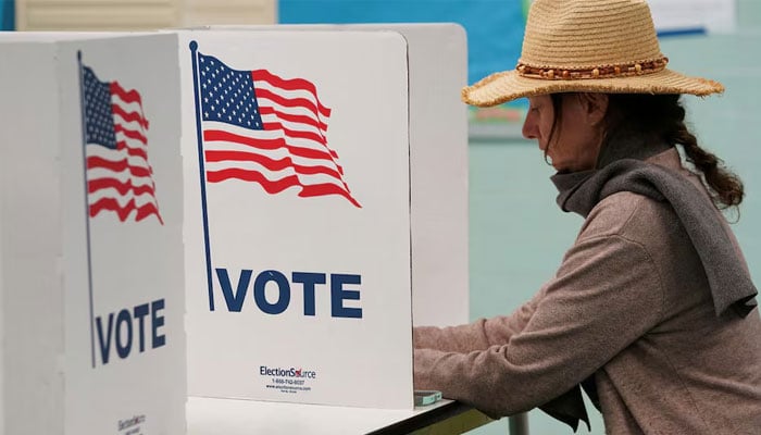 A voter casts her ballot at a polling station on Election Day in Falls Church, Virginia, US, November 7, 2023 — Reuters.