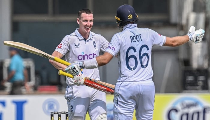 Englands Harry Brook (left) celebrates with Joe Root after scoring a double century during first Test between Pakistan and England at the Multan Cricket Stadium in Multan on October 10, 2024. —AFP