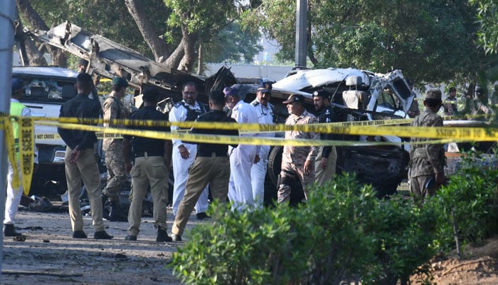 Security officials examine the site of the explosion targeting a convoy of foreigners near the Jinnah International Airport in Karachi, Pakistan on October 07, 2024. — Online