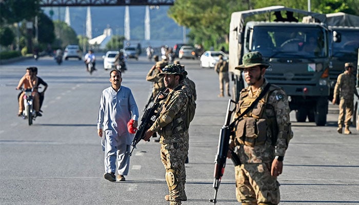 Pakistan Army soldiers stand guard in anticipation of PTI founder Imran Khans supporters and activists amid the ongoing protests in Islamabad on October 6, 2024. — AFP