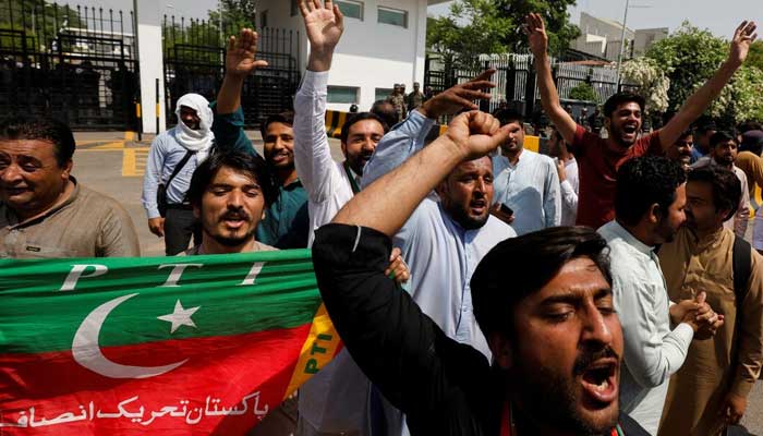 PTI supporters chant slogans in support of former prime minister Imran Khan, outside parliament building Islamabad on April 3, 2022. — Reuters