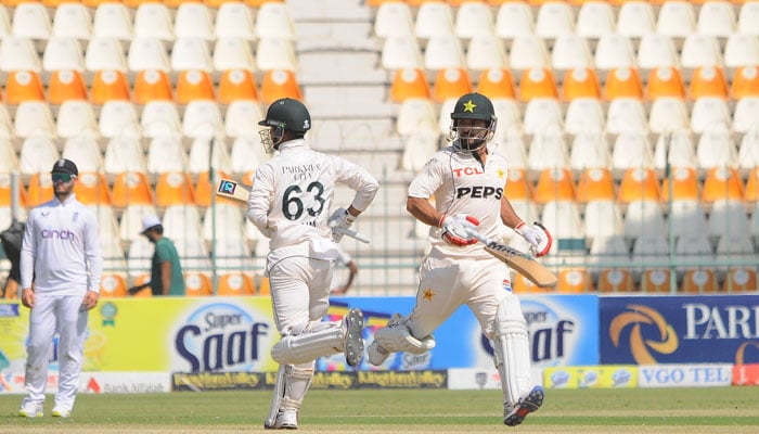 Pakistani batters Kamran Ghulam (right) and Saim Ayub run between the wicket during the first day of the second Test against England at the Multan Cricket Stadium on October 15, 2024. — PCB