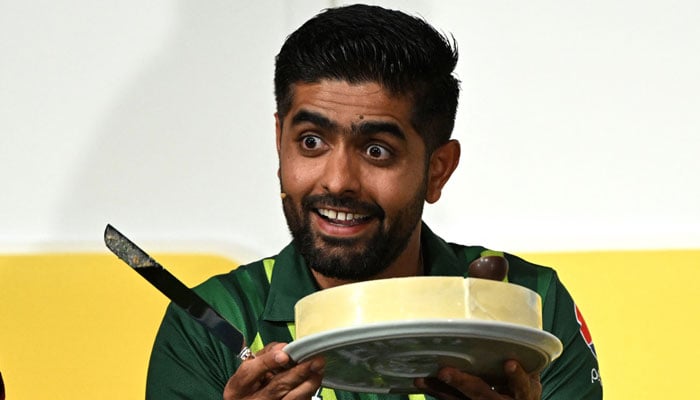 Pakistan captain Babar Azam holds up his birthday cake at a press conference in Melbourne on October 15, 2022, ahead of the 2022 T20 World Cup cricket tournament. — AFP