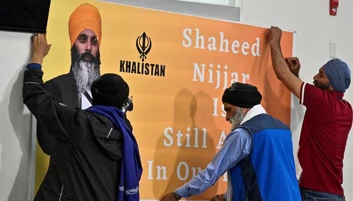 Men hang a sign that reads Shaheed Nijjar is still alive in our hearts prior to a press conference held at Guru Nanak Sikh Gurdwara, site of the 2023 murder of Sikh separatist leader Hardeep Singh Nijjar, in Surrey, British Columbia, Canada May 3, 2024. — Reuters